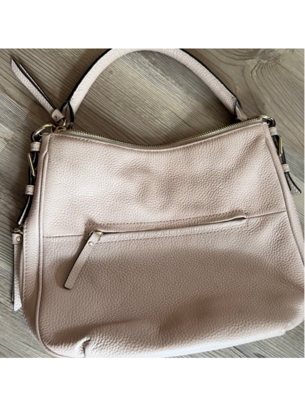 Kate Spade New York hobo bag is crafted from blush pink pebbled leather